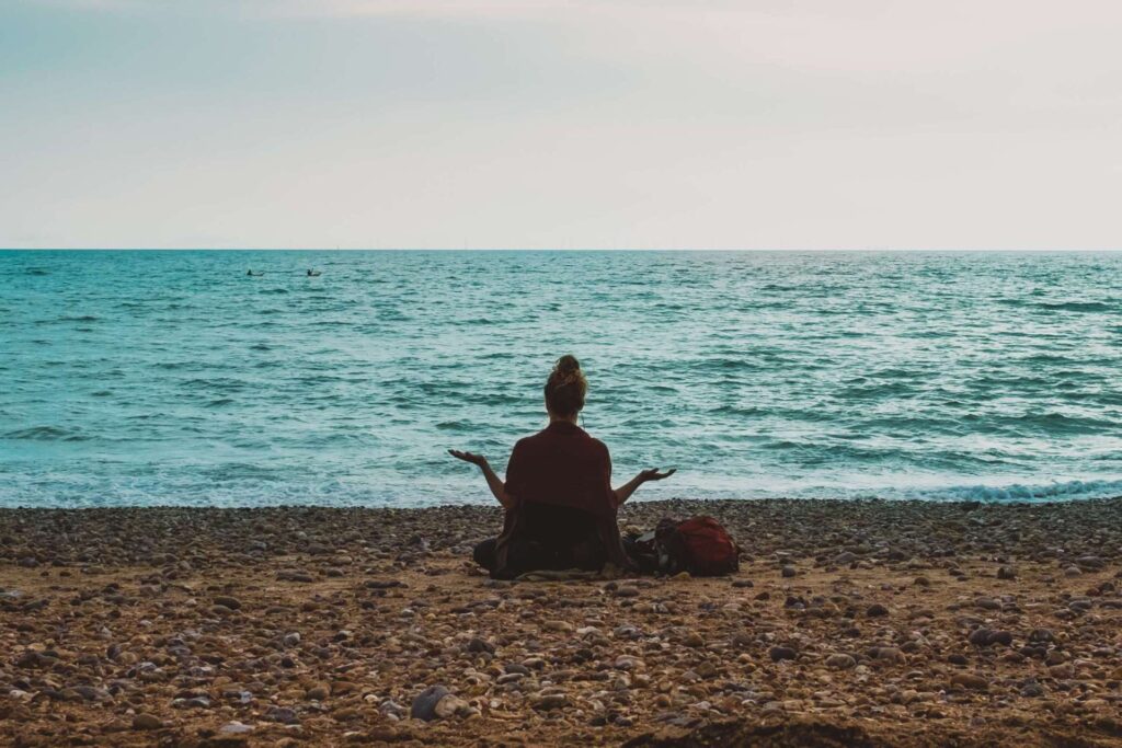 woman meditating on a beach cbt in wakefield