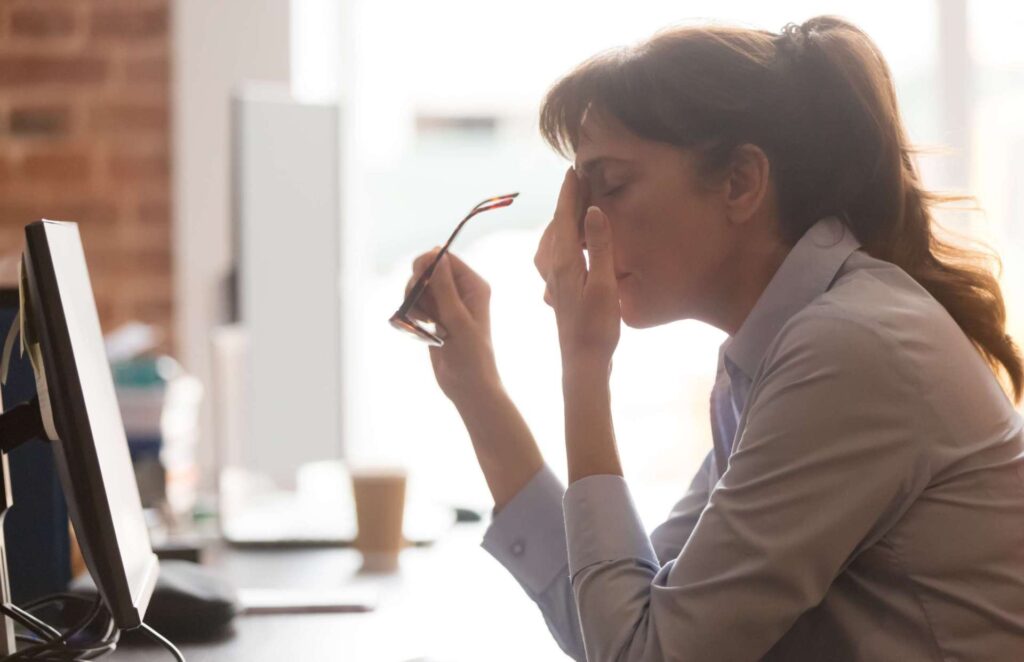 woman sad at desk hypnotherapy cbt